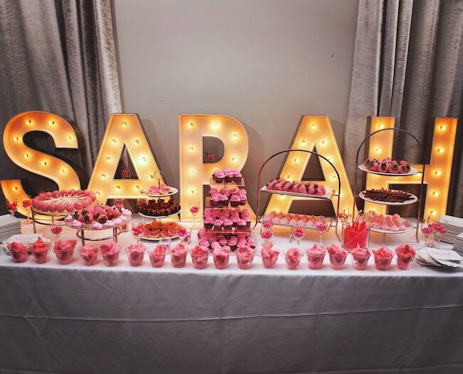 Dessert table backed by giant light-up letters