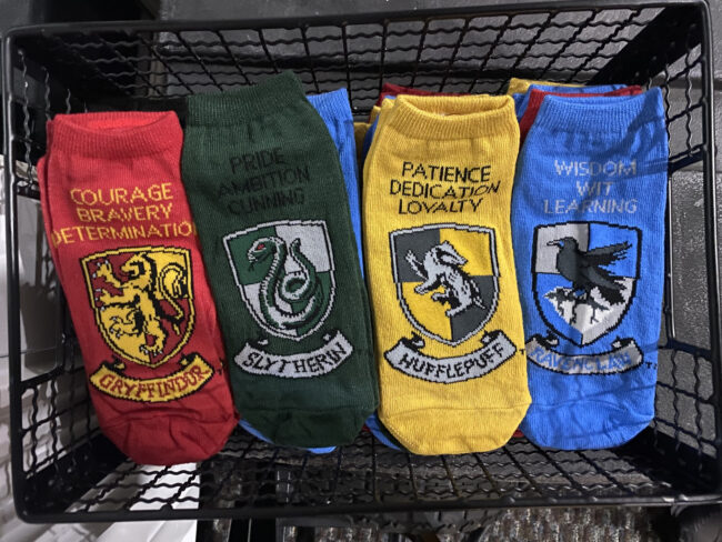 Harry Potter-themed socks featuring Hogwarts schools.