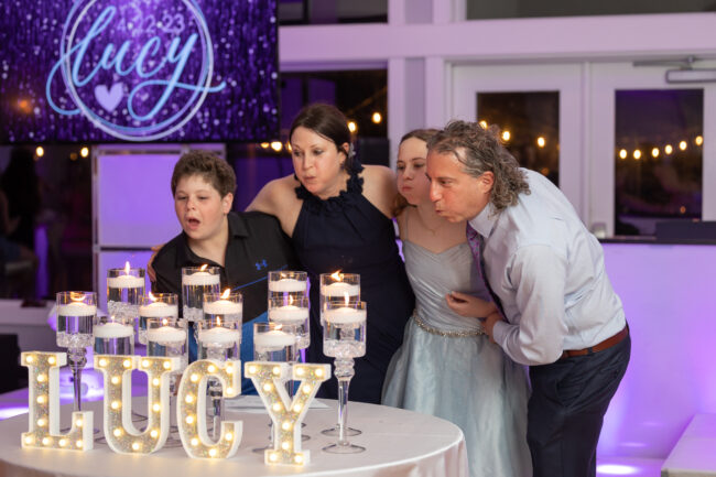 Family blowing out candles during candle lighting