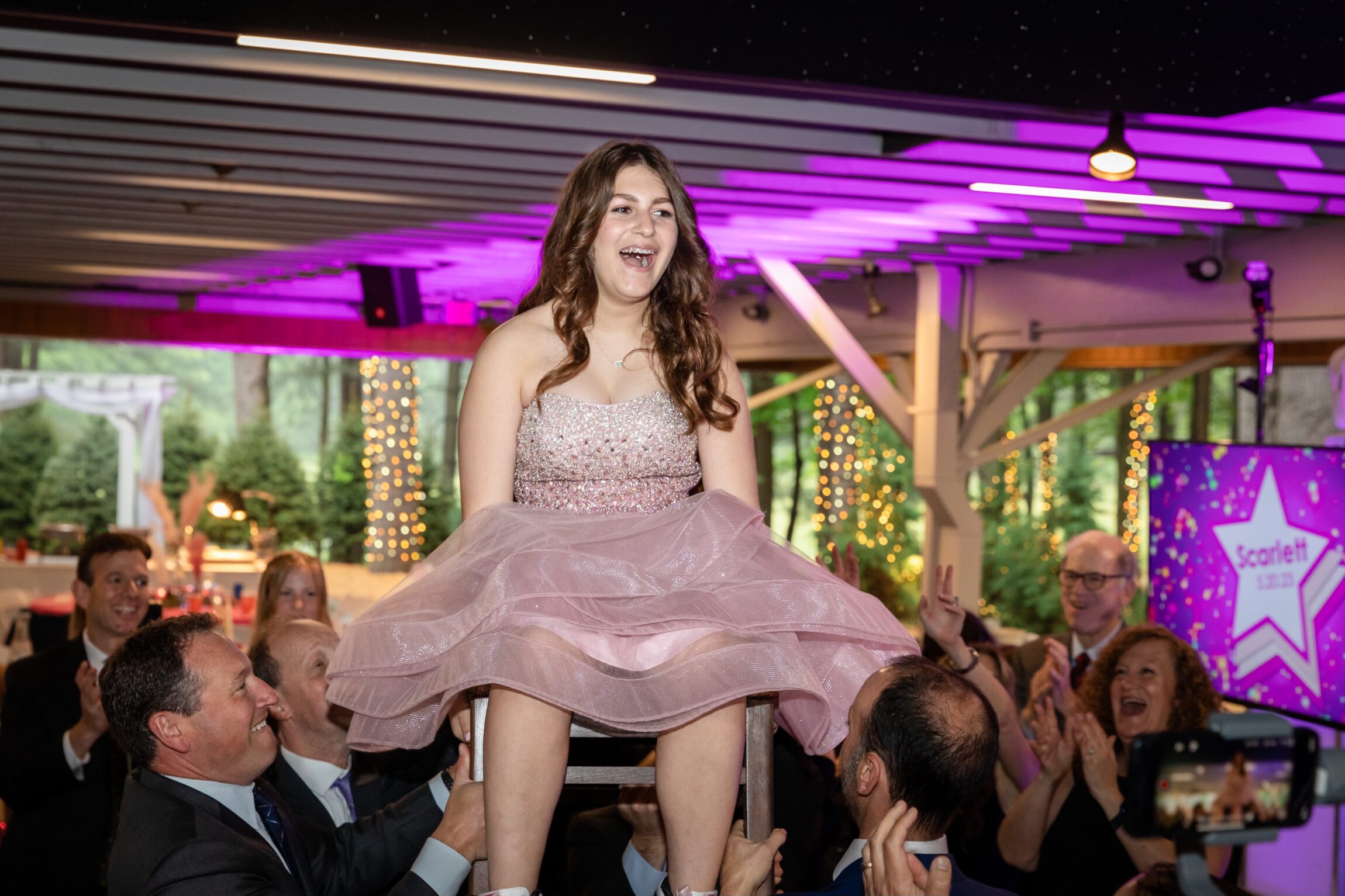 Mitzvah girl up in chair during Hora