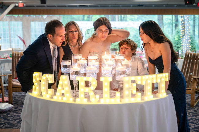 Mitzvah family blowing out candles at candle lighting