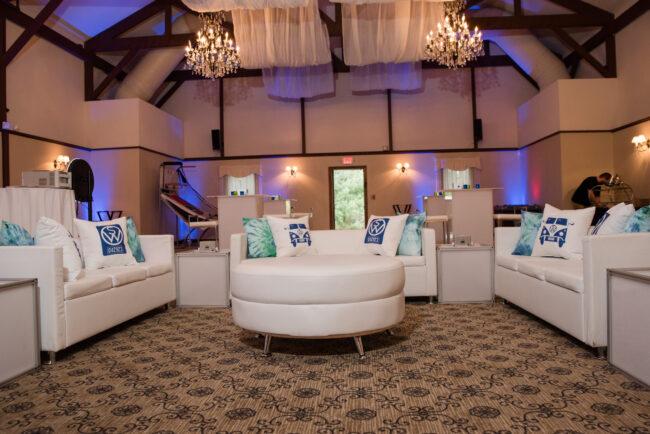 Kids lounge with logo'd pillows and white furniture