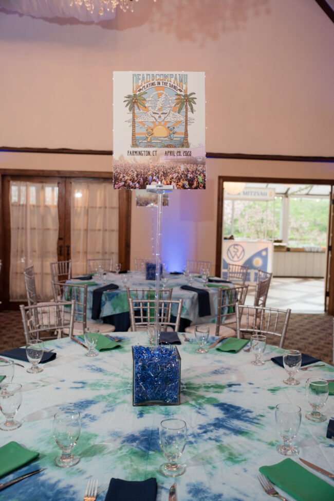 Table setting with music festival centerpiece and tie-dye table cloth