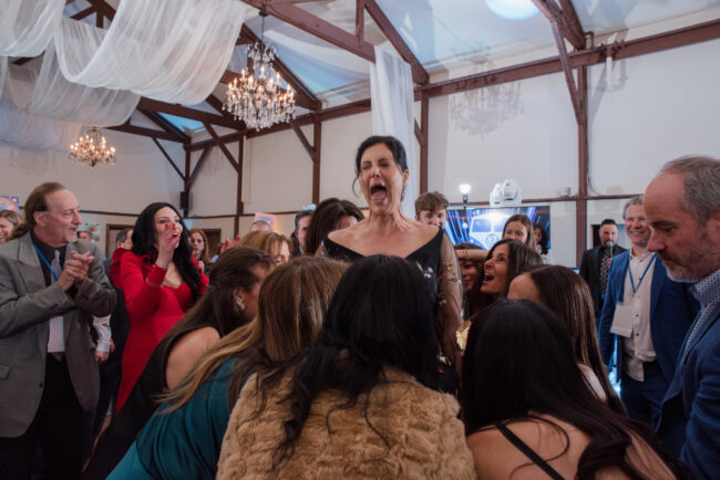 Mitzvah mom lifted in chair during hora