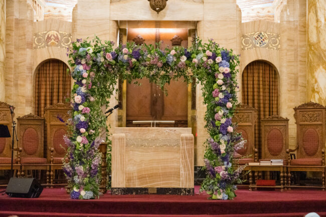 wide shot of chuppah adorned with flowers