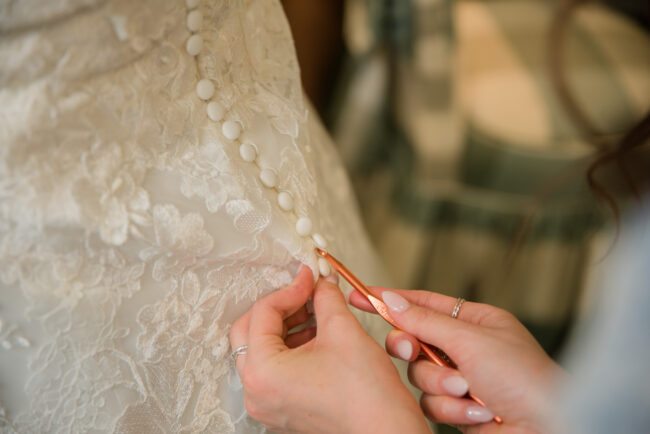 Buttoning up wedding dress