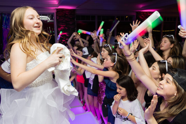 Mitzvah girl giving away swag during party