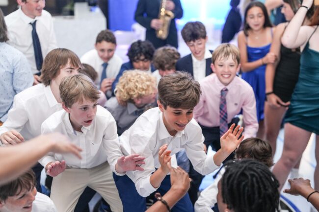 mitzvah boy dancing with friends