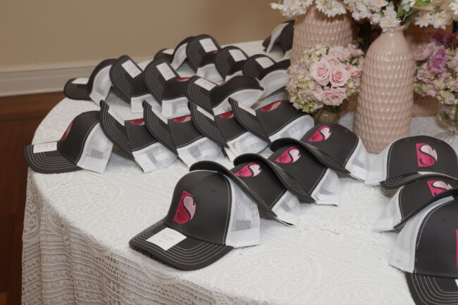 Trucker-hat place cards with party logo