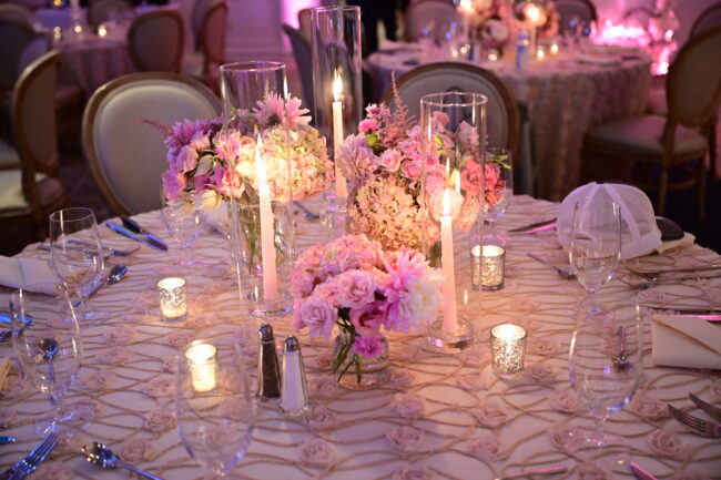 Floral centerpiece with votives and flowered linen