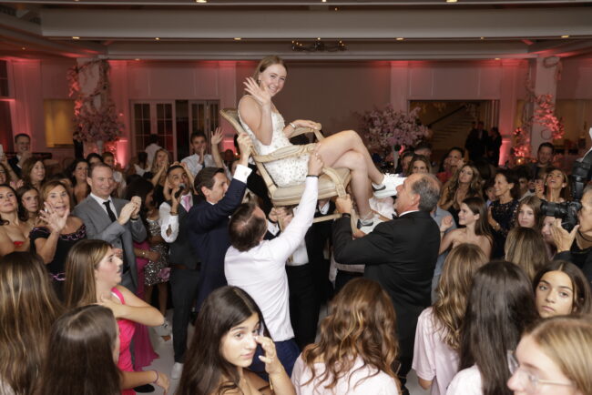 Mitzvah girl up in chair during Hora