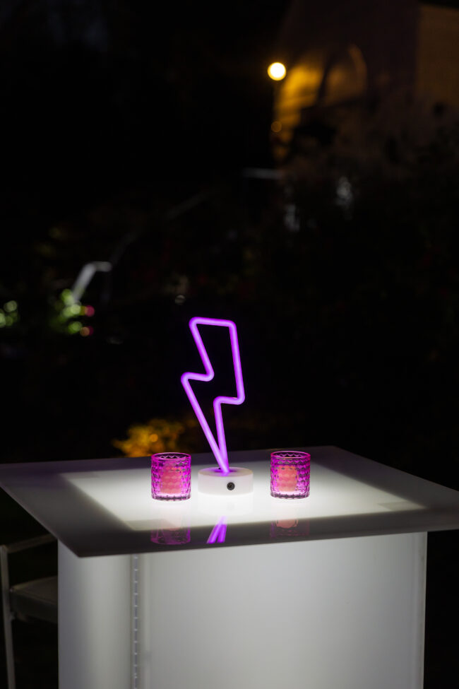 Neon lightning bolt centerpiece with pink votives