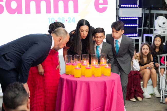 Mitzvah family blows out candles