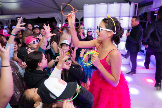 Mitzvah girl tosses out neon giveaways during blacklight party