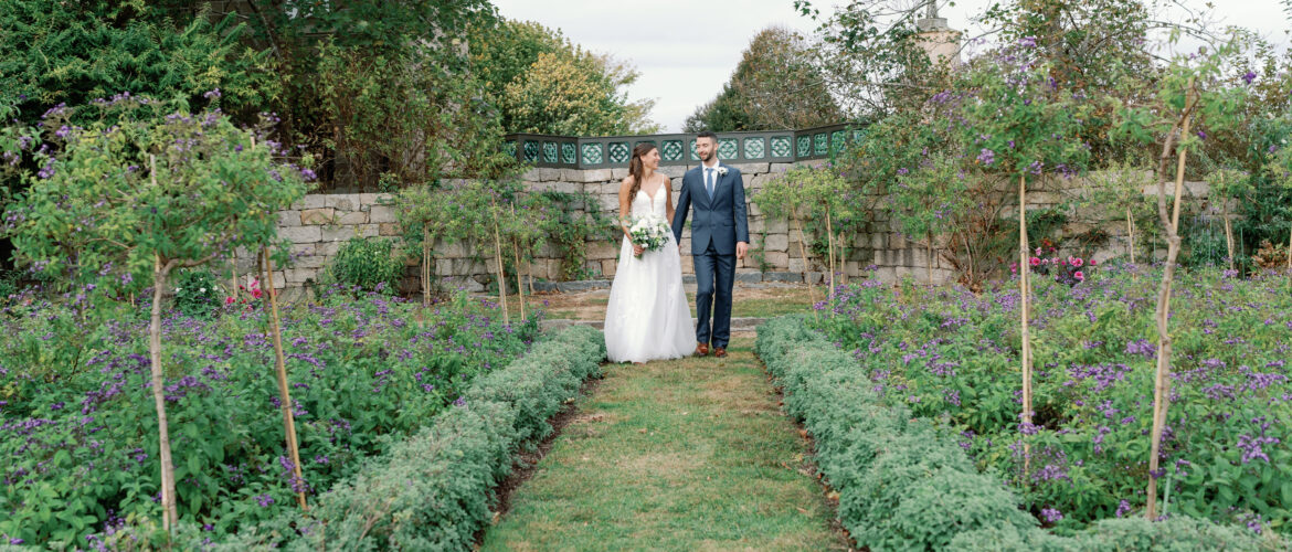 Soon-to-be bride and groom stroll the garden pre-ceremony