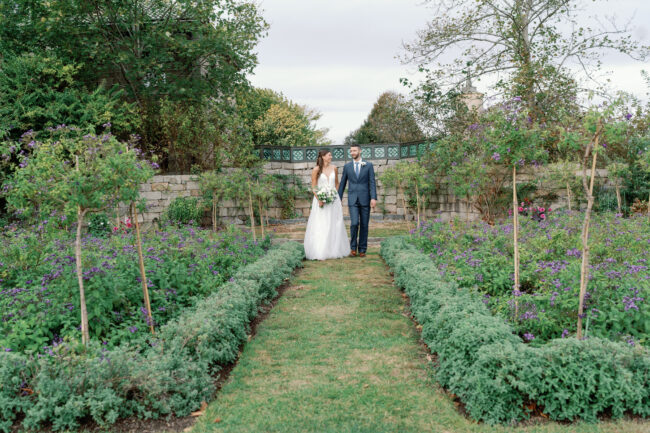 Soon-to-be bride and groom stroll the garden pre-ceremony