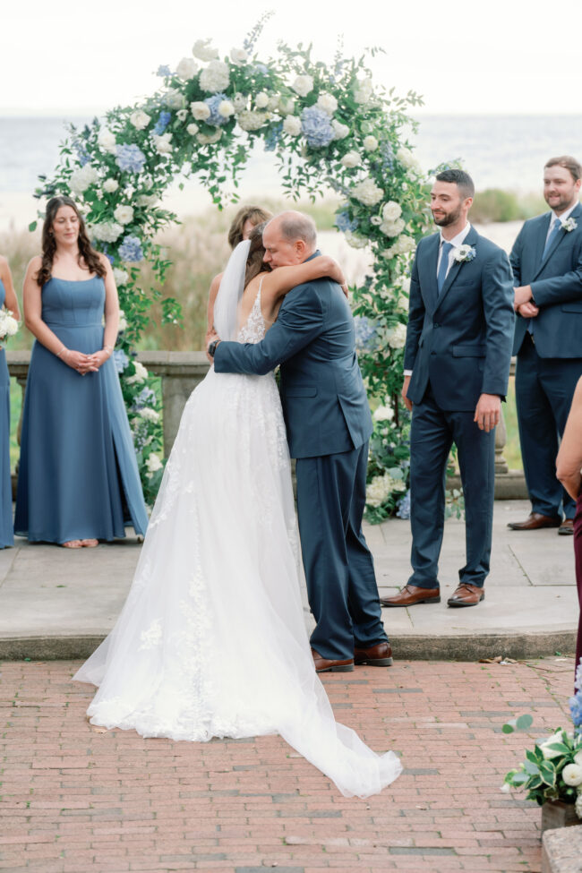Bride and Father of Bride embrace during ceremony