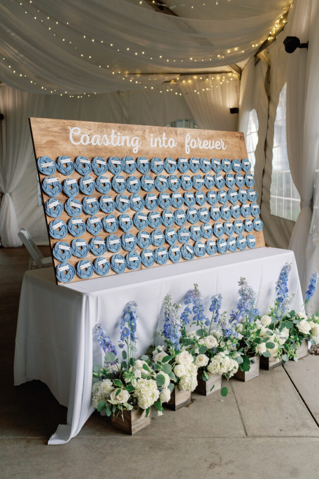 Nautical themed escort cards on a large display board