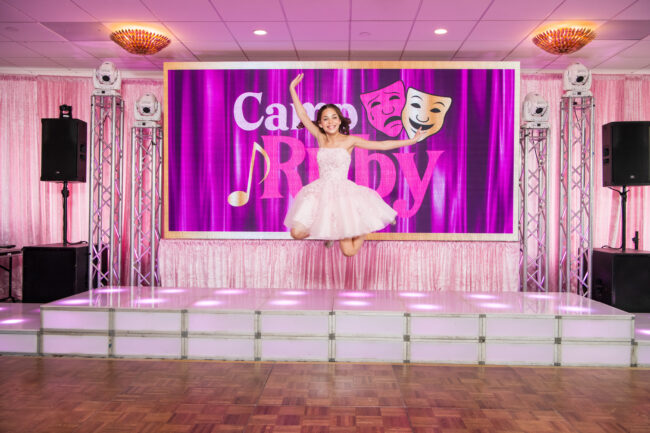 Mitzvah girl jumping into her party