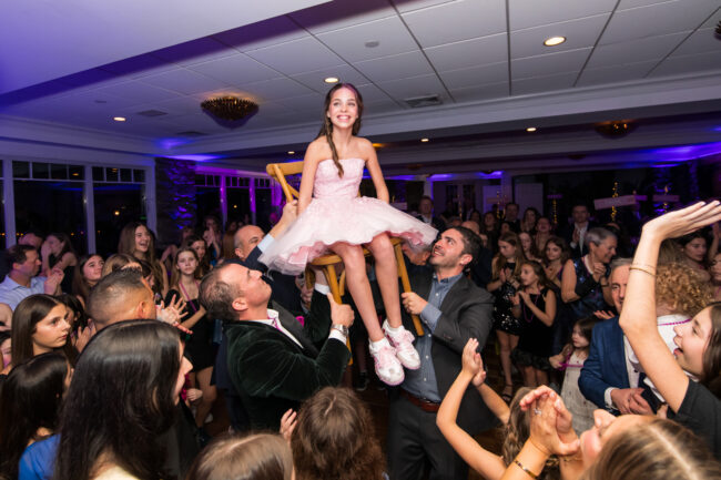 Mitzvah girl up in chair during the Hora
